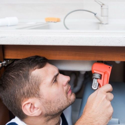 Plumber checking water leak